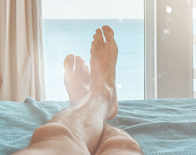 man relaxing his feet